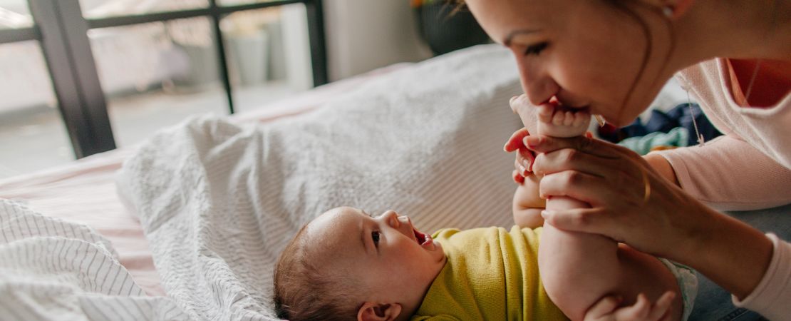 father with baby and two older children outside of block of flats