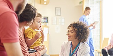 parents with a small child seeing a woman doctor