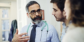 doctor talking to young couple